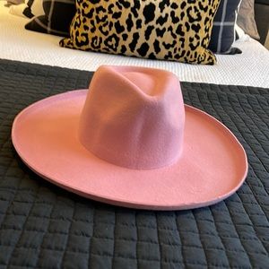 Lack of color hat in pink. Slightly worn—as seen with make up on the inside rim